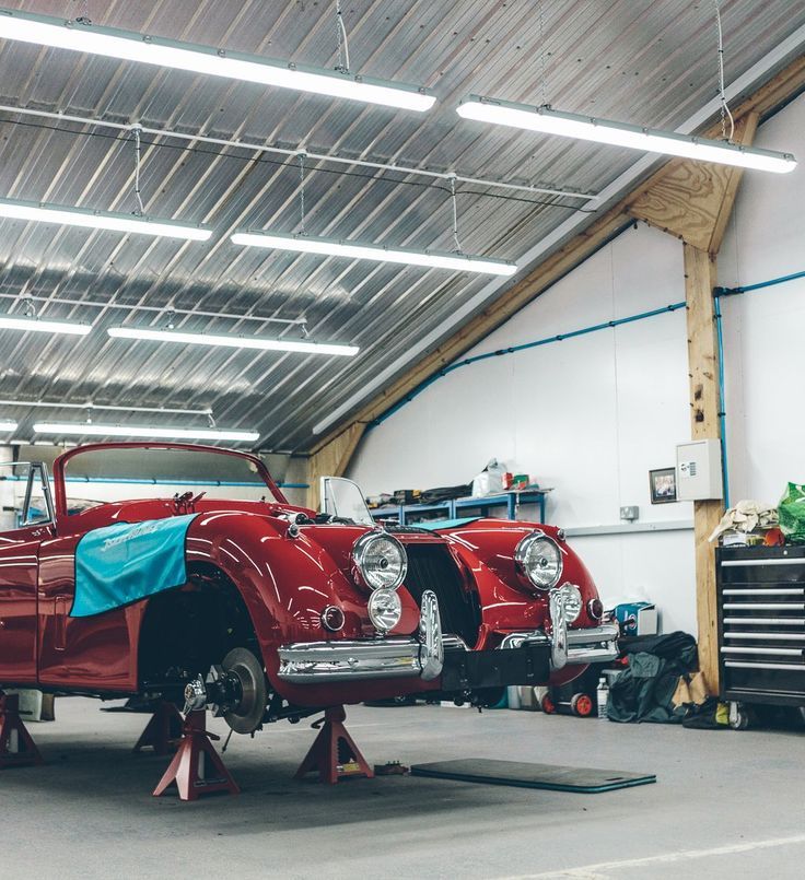 Classic car on stands mid-restoration in a workshop